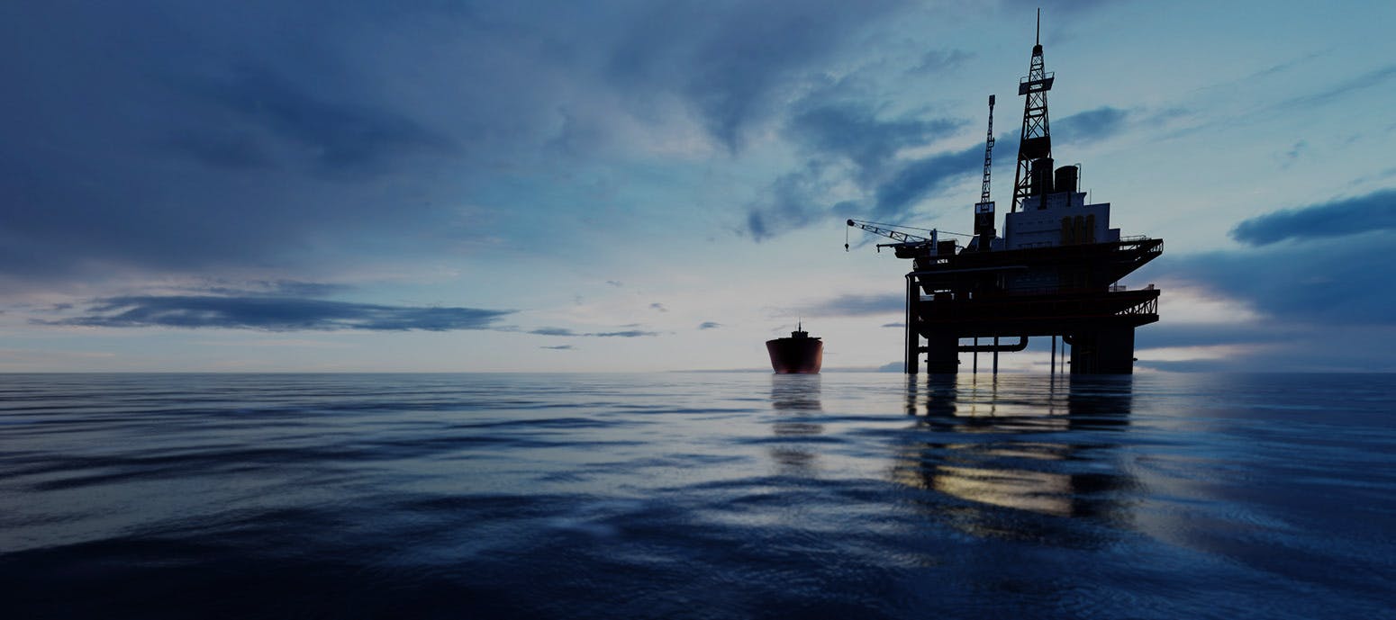 peaceful image of an oil rig in the ocean at sunset